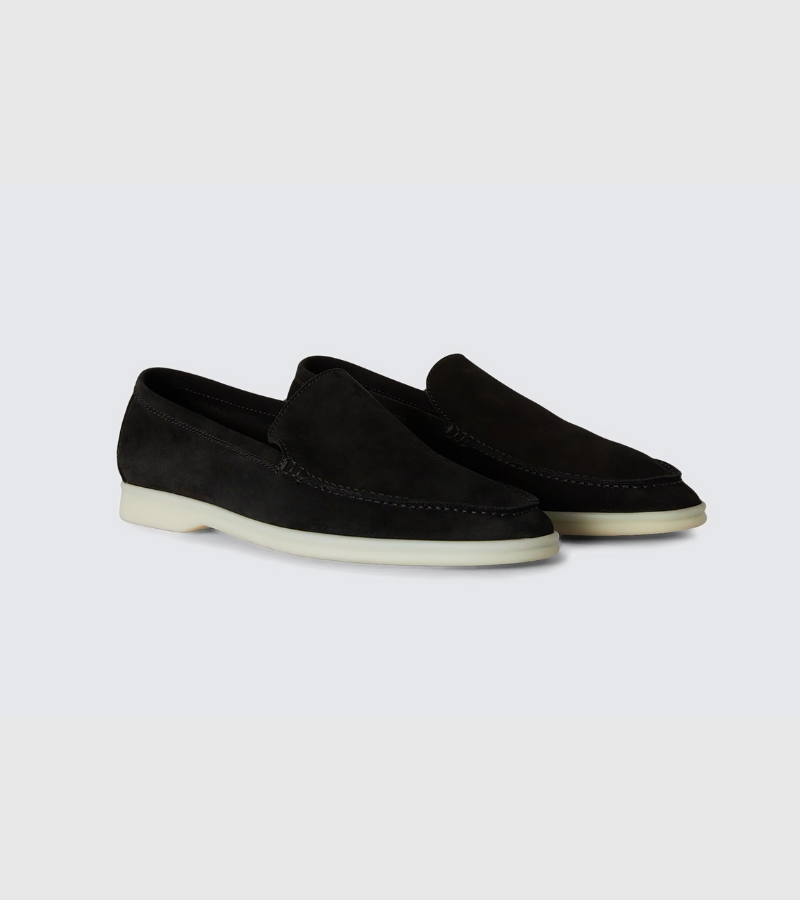 Black loafers on a light gray background