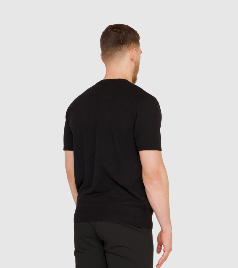 Man wearing a black t-shirt on a white background