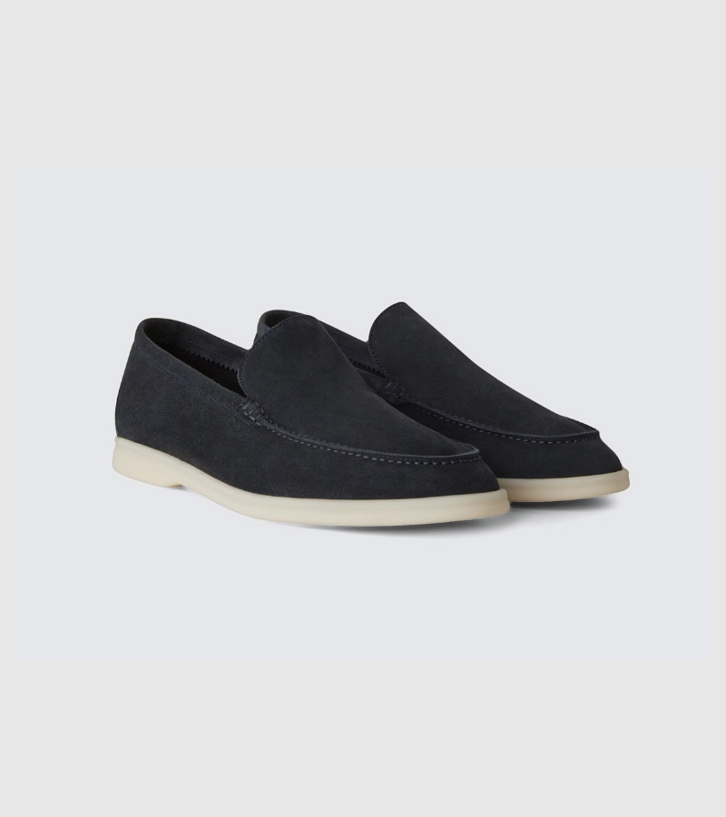 Pair of black loafers on a light gray background