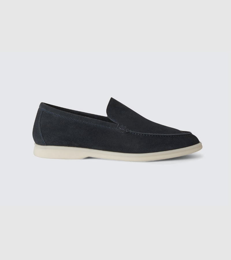 Black loafer shoe on a light gray background