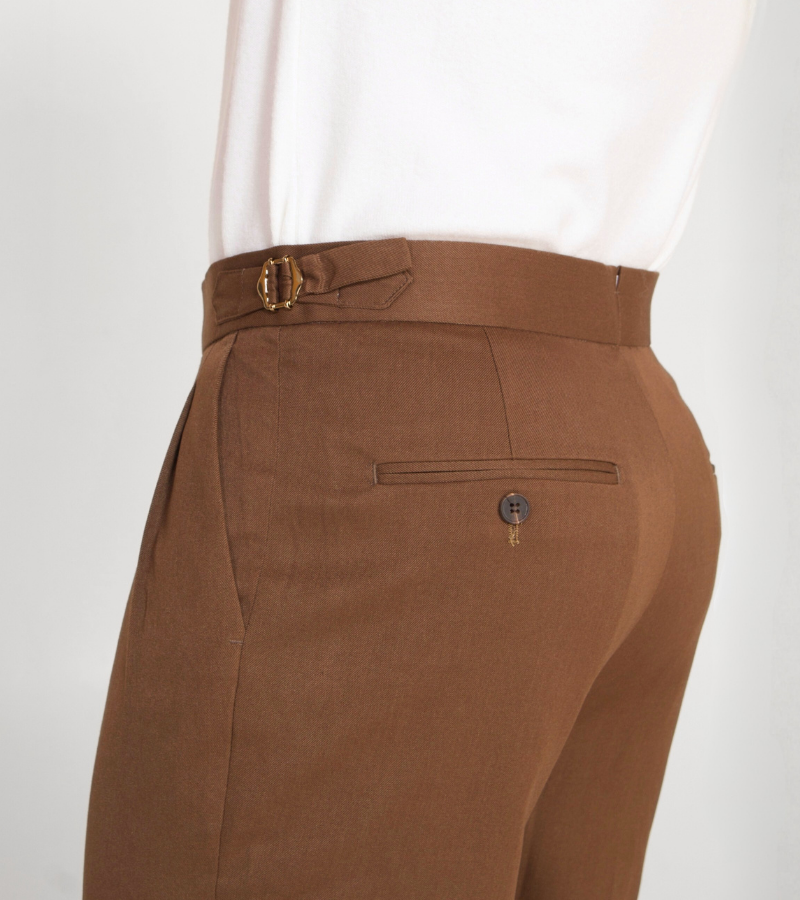 Brown pants with a belt and button on a white background
